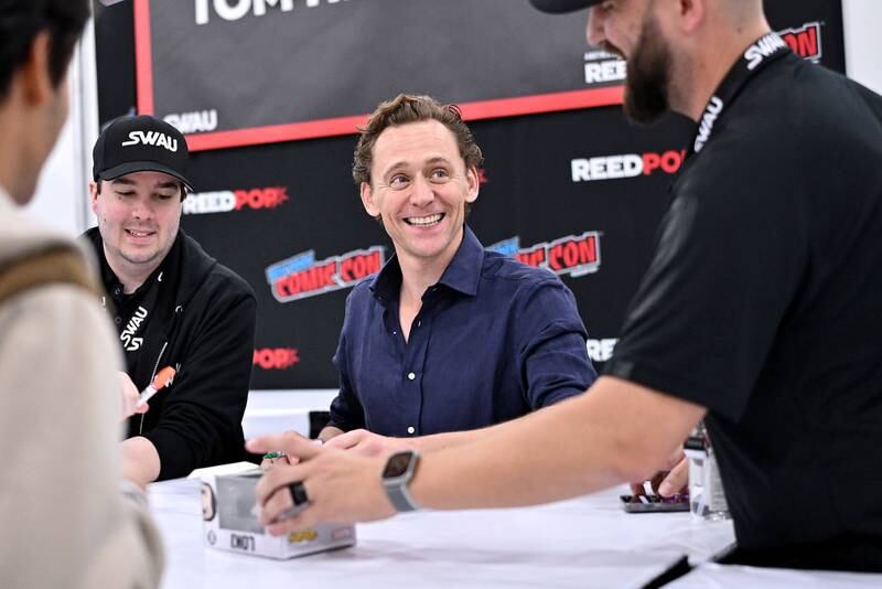 NEW YORK, NEW YORK - OCTOBER 14: Tom Hiddleston signs autographs during New York Comic Con 2023 - Day 3 at Javits Center on October 14, 2023 in New York City. (Photo by Roy Rochlin/Getty Images for ReedPop)